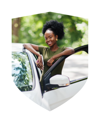 Woman smiling with their newly insured vehicle