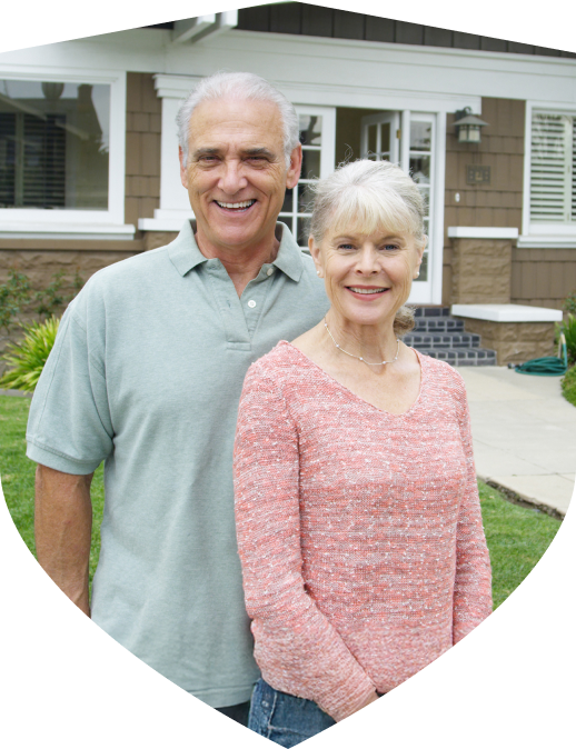 Homeowners standing in front of their home